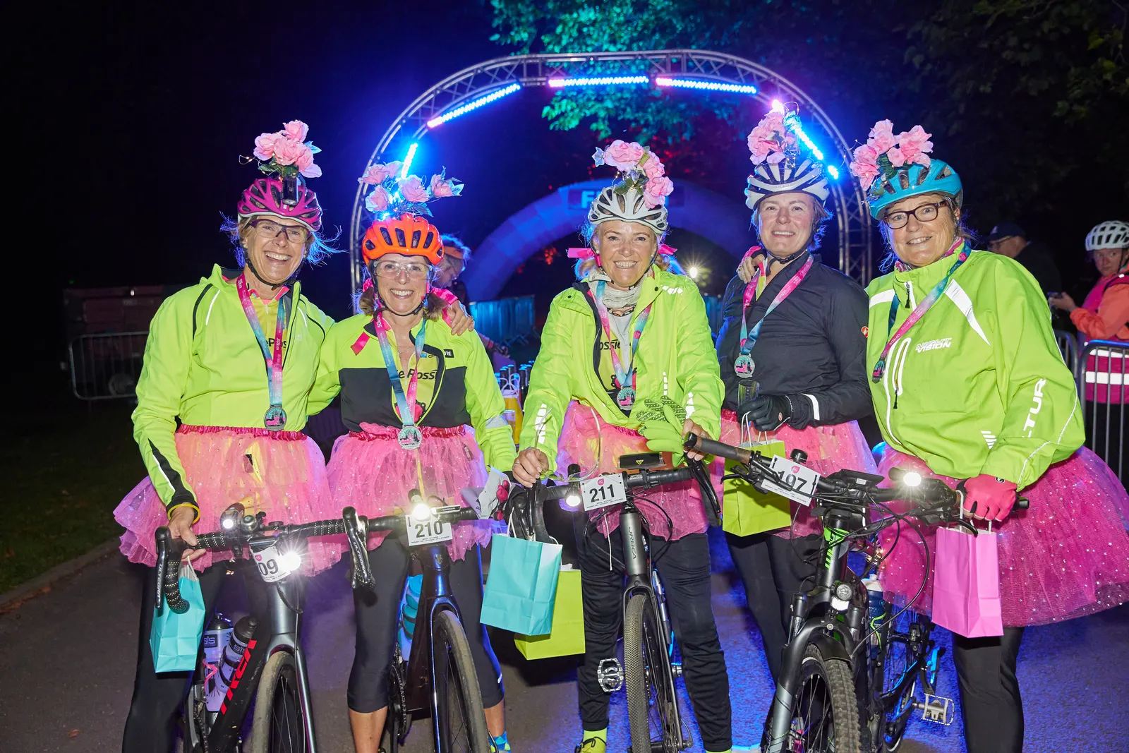 Riders celebrating with their medals at Ride the Night