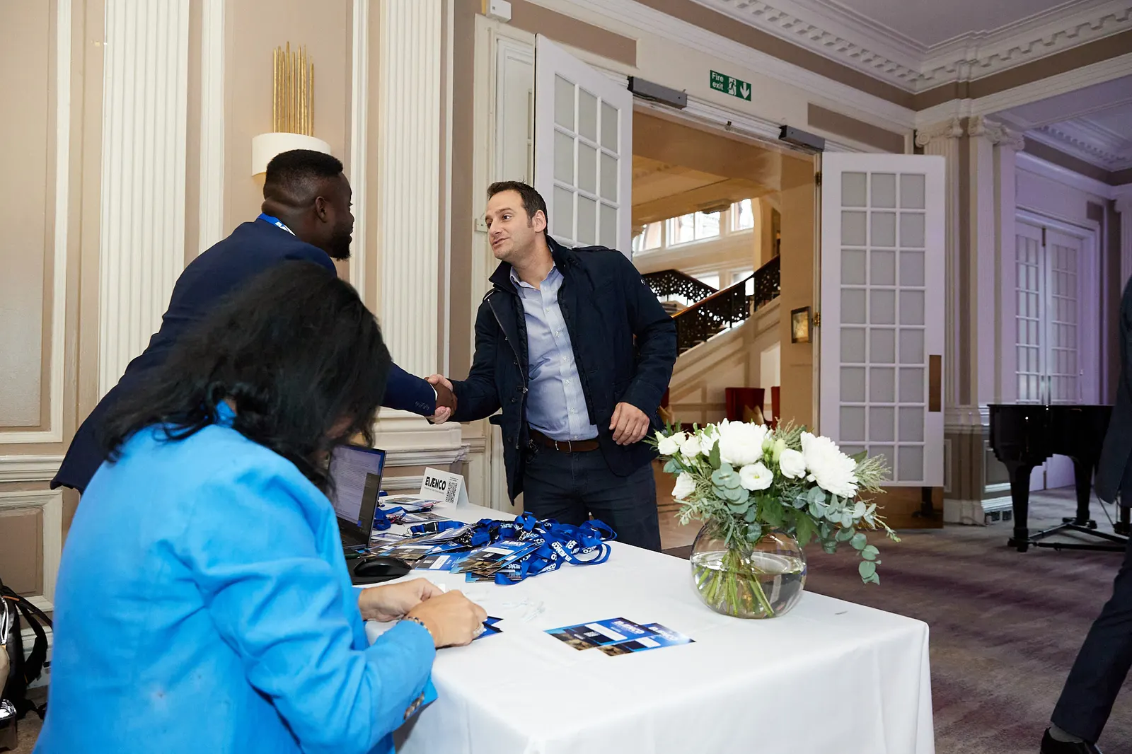 Delegate welcomed at the registration desk of an Edinburgh fund forum