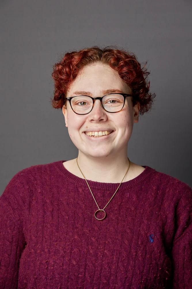 Professional corporate headshot on a grey backdrop at a Manchester office