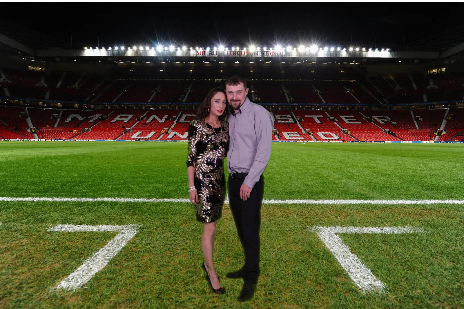 Couple composited pitch-side at Old Trafford with a green screen stadium backdrop